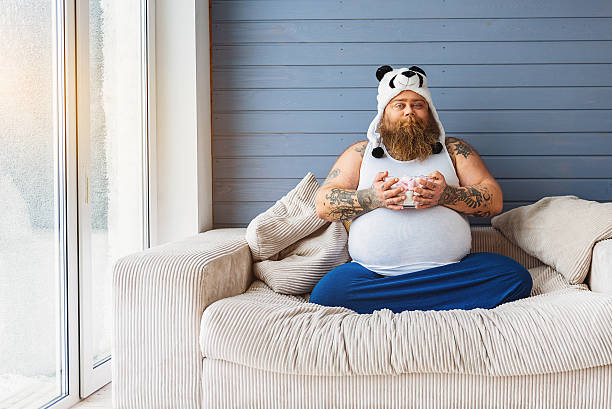 istock Funny fat man having unhealthy breakfast 638738690