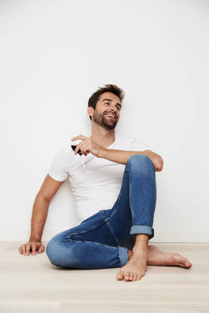 Dude with wine Guy relaxing with red wine sitting on floor stock pictures, royalty-free photos & images