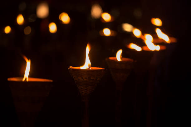Traditional wooden torch flame with bokeh at night