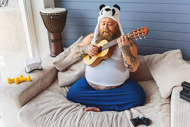 istock Cheerful thick man playing musical instrument 638741810