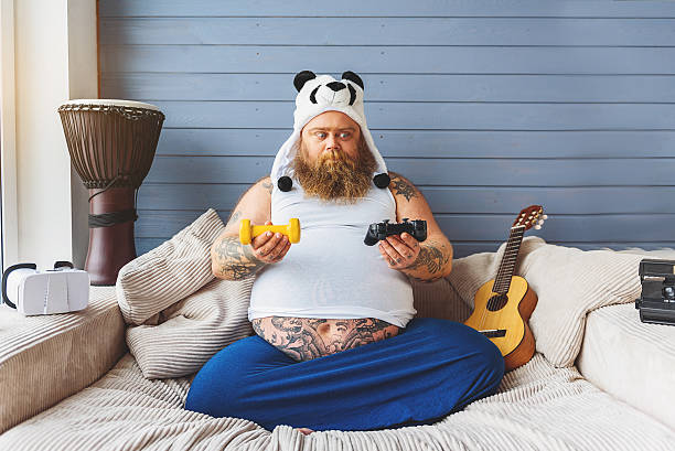 istock Fat man making choice between sport and game 638742358