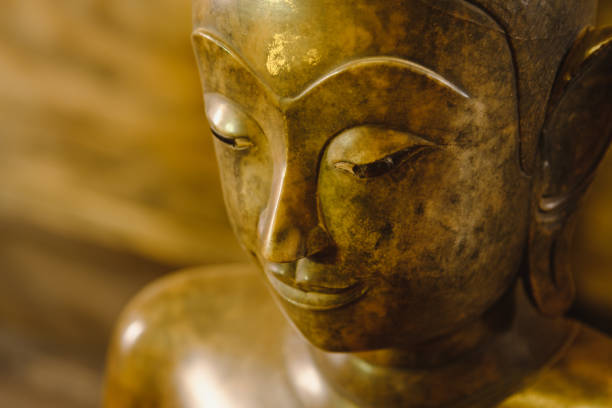 close up face on buddha head statue with lighting effect.  Selective focus face buddha statue.
