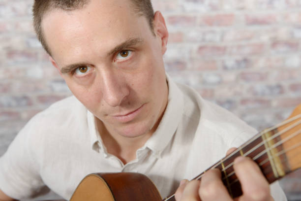 istock man with an acoustic guitar in his hands 638745632