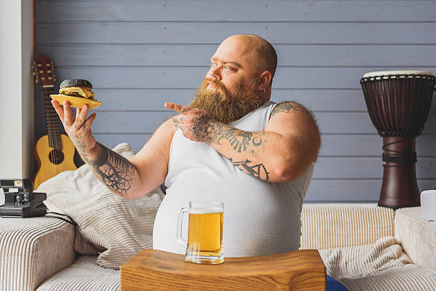 istock Severe thick guy eating unhealthy food 638746282
