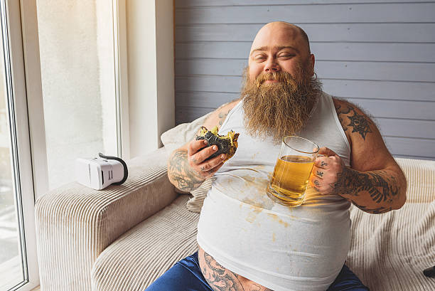 istock Satisfied fat guy enjoying unhealthy food 638749080