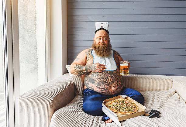 istock Male glutton eating junk food with alcohol 638750512