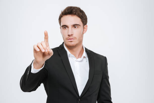 istock Attractive businessman standing at studio and pointing. 638750626