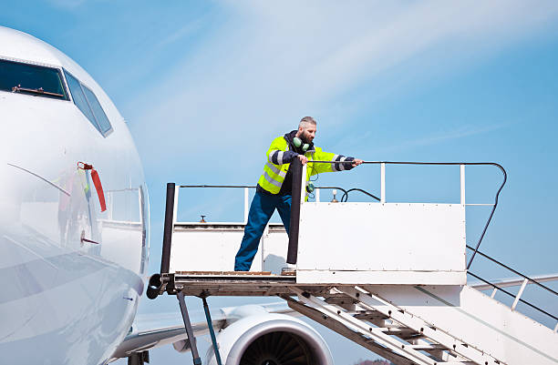 istock Airport worker on the aircraft stairs 638751926