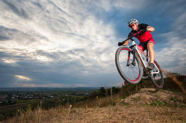 istock Mountain cyclist riding donwhill against blue evening sky 638751948