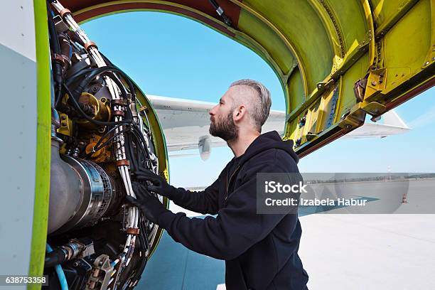 Aircraft Mechnic Examining Aircraft Engine Stock Photo - Download Image Now - Adult, Air Vehicle, Airfield