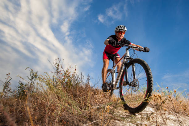 istock Cyclist riding his bike down on mountain trail 638753424