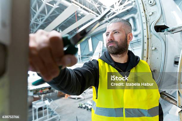 Aircraft Engineer In A Hangar Stock Photo - Download Image Now - Airplane Mechanic, Adult, Air Vehicle
