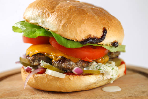 istock Tasty cheese beef burger with lettuce, cheddar, barbecue sauce 638754196