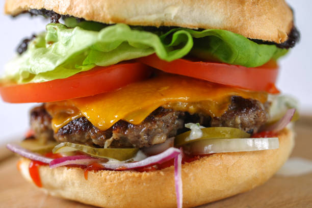 istock Tasty cheese beef burger with lettuce, cheddar, barbecue sauce 638754236