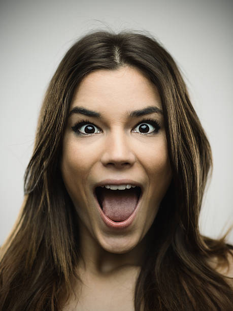 istock Excited woman screaming against gray background 638756174