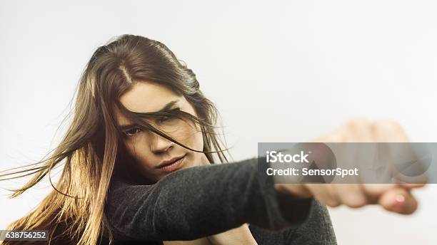 Portrait Of Angry Woman Punching The Air Stock Photo - Download Image Now - Punching, Women, Fist