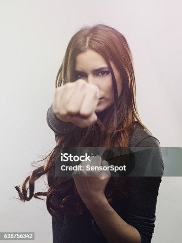 istock Portrait of angry woman punching the air 638756342