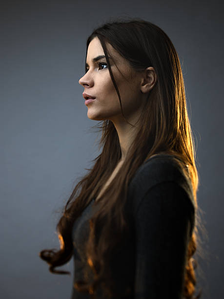 Beautiful woman posing against dark background