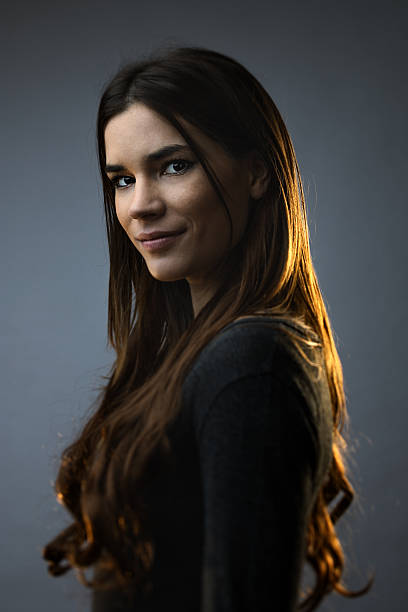 istock Cheerful woman smiling against dark background 638756682