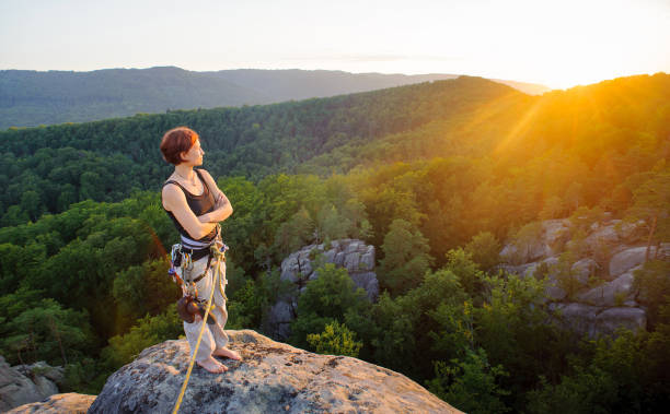 istock Girl climber on mountain peak on high altitude in evening 638756966