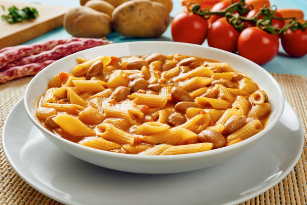 istock Close-up of pasta with beans on white dish 638757126