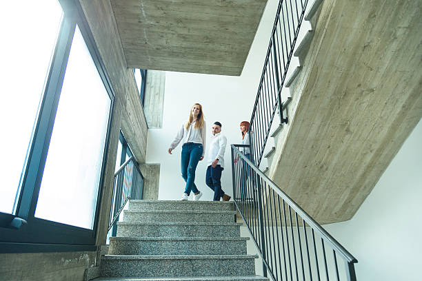 istock happiness friends young colleagues moving down the staircase 638757838