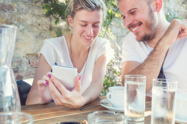 istock Urban friends using cellphone in a coffee-shop. 638759584