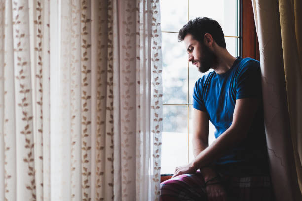 istock Young sad mad sitting by the window 638759962