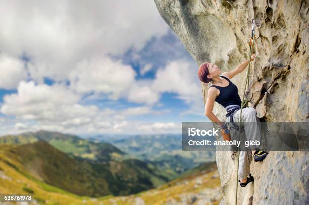 Female Rock Climber On Steep Overhanging Rock Cliff Stock Photo - Download Image Now