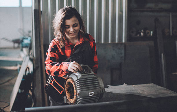 istock Woman machinist examining electric motor with voltmeter 638762060