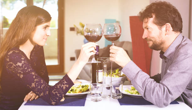 istock Couple in love looking each other in the eyes toasting 638763710