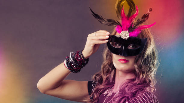 istock Woman with carnival venetian mask on dark 638766176