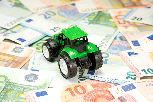 A tractor and many different euro banknotes