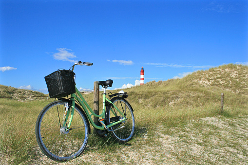 A bicycle leaning on a fence on the german north sea island of Amrum