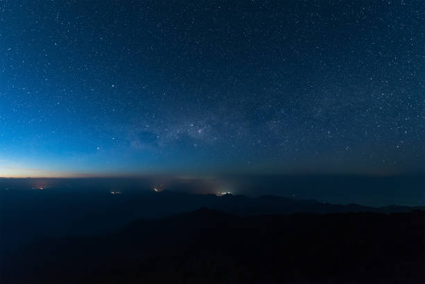 istock Stars illuminated above the dark silhouette mountain before sunrise. 638768386