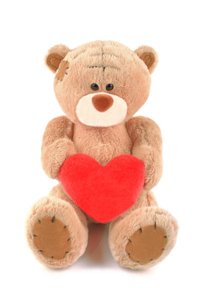 istock Brown teddy bear toy with heart isolated on white background 638769170