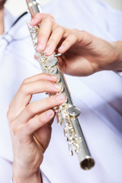 istock Hands of young man playing the flute 638770116