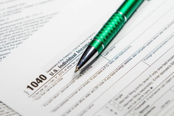 istock 1040 Tax Return Form with a Pen 638771440