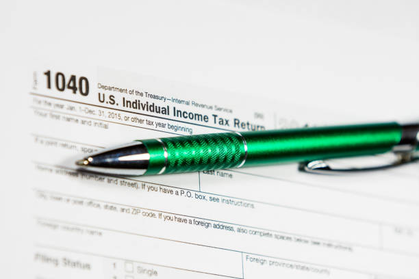 istock 1040 Tax Return Form with a Pen 638771500