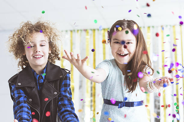 Kids having party Happy kids having party, throwing colorful confetti childrens day photos stock pictures, royalty-free photos & images