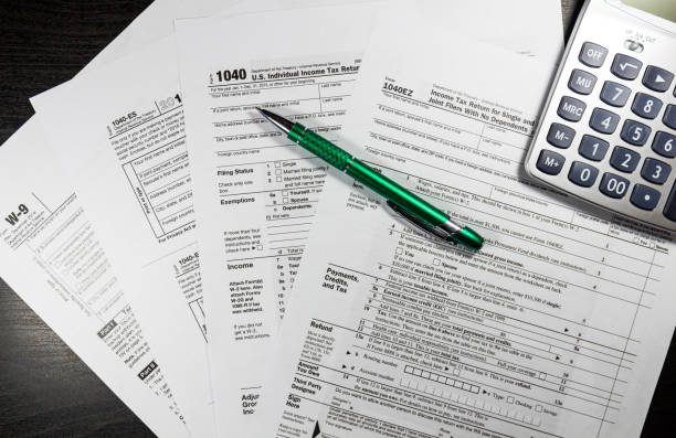 istock 1040 Tax Return Form with a Pen 638771790