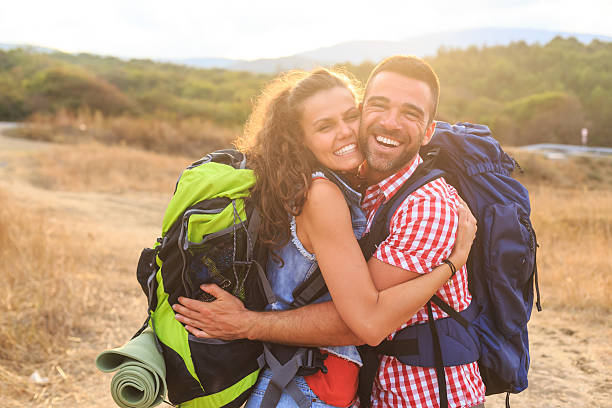 istock Cheerful couple backpackers embracing 638772524