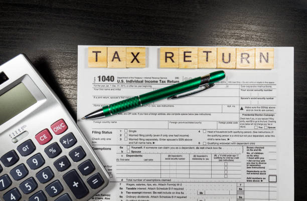 istock 1040 Tax Return Form with a Pen 638773016