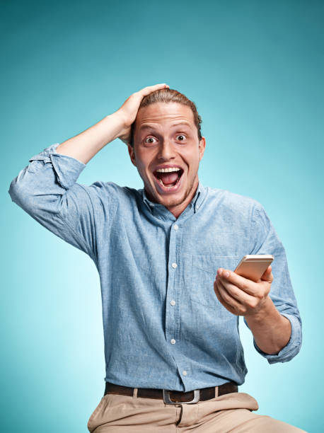 istock The young smiling caucasian man on blue background 638774166