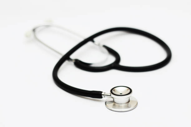 stethoscope on a white surface stock photo