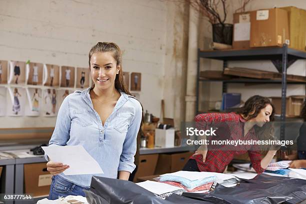 Young Woman Packing Orders For Distribution Smiles To Camera Stock Photo - Download Image Now