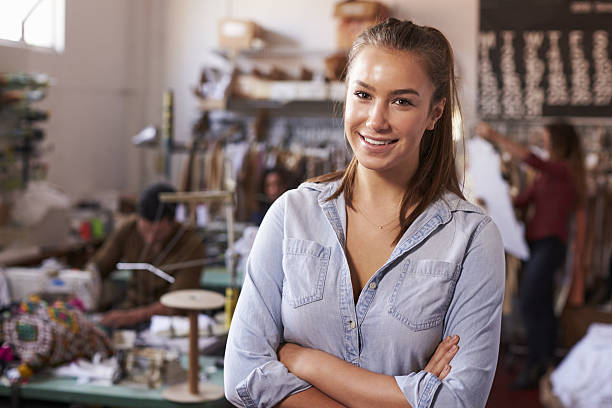 istock Smiling white female trainee in clothing design studio 638777586