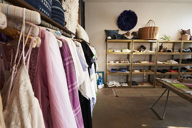 istock Clothes hanging on a rail in a clothes and accessories shop 638777890