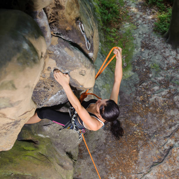 istock Female climber climbing big boulder in nature with rope 638777900