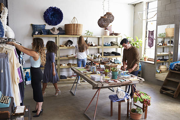 istock Customers and staff in a busy clothes shop 638778306